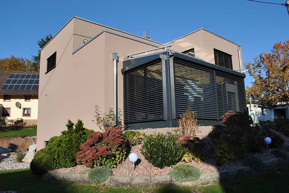 Braunes Haus mit Wintergarten und Garten